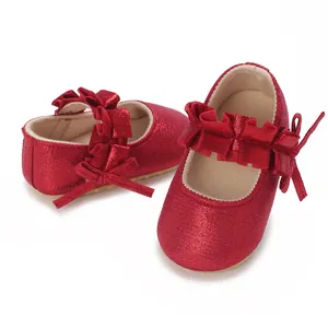 Detailed macro view of red glitter baby shoes featuring ruffled strap and bow decoration