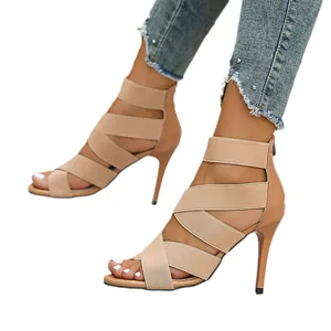 Elegant nude high-heeled sandals with elastic cross straps and back zipper closure.