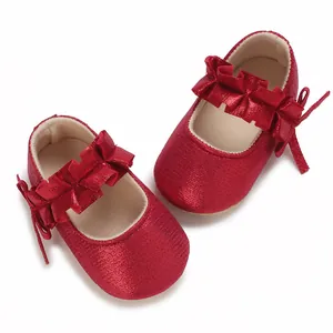 Close-up of shiny red baby princess shoes with ruffle straps for 0-1 year olds