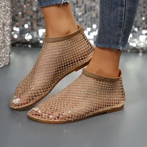 Close-up view of elegant rhinestone mesh flat sandals with a stylish round toe design
