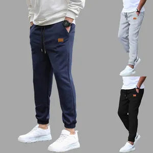 Detail view showing three color options of men's casual joggers with drawstring waist