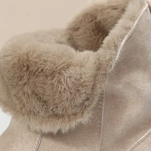 Gros plan sur la doublure en fausse fourrure et le daim beige des bottes de neige d'hiver
