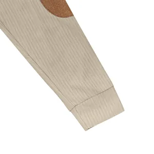 Detail shot of men's ribbed knit sweatshirt sleeve featuring a brown contrast elbow patch