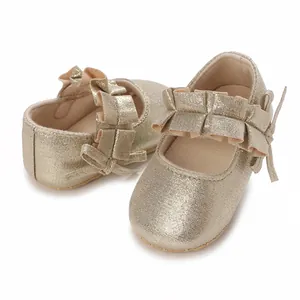 Detailed view of champagne gold glitter baby girl princess shoes with ruffles and bow