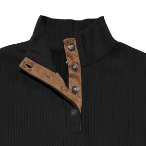 Detail of men's black ribbed sweatshirt with stand-up collar and suede button placket.