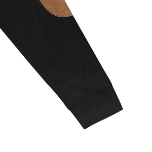Close-up view of the black ribbed fabric and brown elbow patch detail on a men's sweatshirt sleeve
