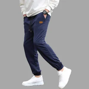 Side view of men's navy blue casual jogger pants with drawstring and pocket detail