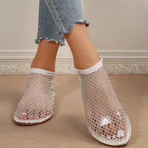 Detail of sparkly rhinestone mesh flat sandals with round toe and bootie style