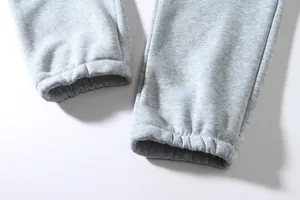 Detail showing high-quality elastic ankle cuffs of grey men's sports sweatpants texture