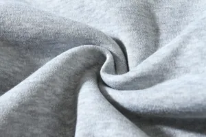 Macro shot of high-quality grey heathered knit fabric showing soft texture for cargo pants