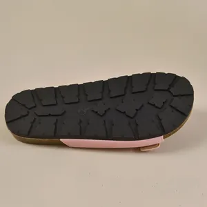 Detailed view of the anti-slip rubber sole on pink retro Birkenstock-style slides.