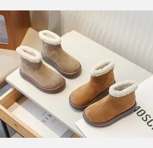 Lifestyle view of brown and khaki girl's thick fleece-lined suede leather snow boots