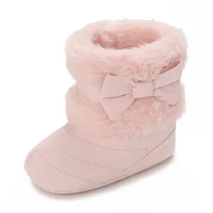 Soft pink baby winter boots with faux fur trim and a cute bow detail for infants.