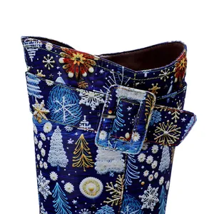 Detail view of festive Christmas snowflake and tree patterns on blue vintage boots