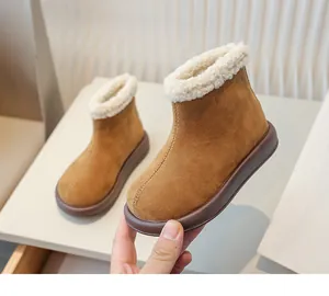 Close-up of girls' warm winter snow boots with thick faux fur lining and suede texture
