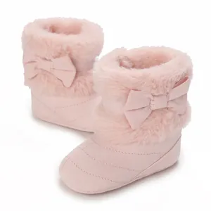 Cozy pink baby boots with faux fur trim and decorative bows for infant girls