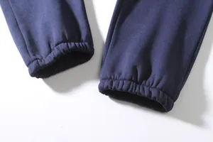 Detailed close-up showing the elasticized cuffs of navy blue men's joggers for autumn wear