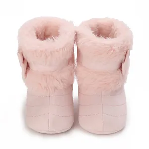 Close-up of pink infant soft sole winter boots with warm faux fur lining