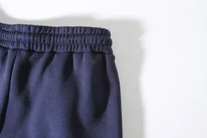 Detail view of the elastic waistband on navy blue men's sports joggers