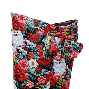 Close-up detail of retro high boots featuring a vibrant Santa Claus and floral print design