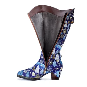 Detail of Christmas patterned high boot showing side zipper and warm grey plush lining.