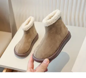 Close-up of children's khaki snow boots with thick white plush lining and rear zipper