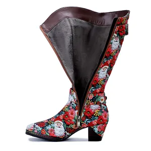 Detail view of Santa Claus print tall boots showing warm fleece lining and side zipper.