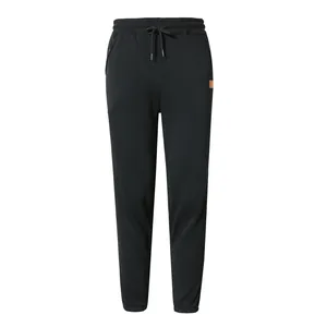 Close-up of black men's joggers with drawstring waist and side patch detail