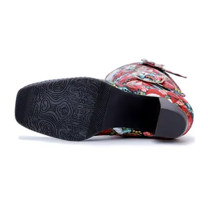 Detailed view of non-slip rubber sole and vintage floral print on high-heeled boots
