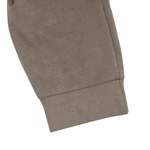 Macro detail view of the ribbed cuff stitching on a taupe suede men's jacket set