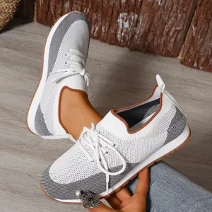 Dettaglio delle sneakers in mesh traspirante da donna con design color-block e lacci.
