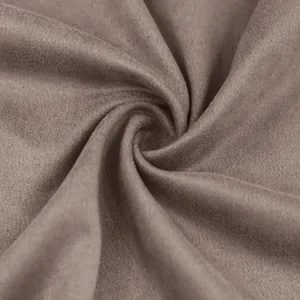 Macro close-up of soft brown suede fabric texture showing fine velvet finish and folds