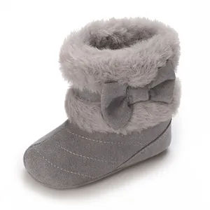 Detailed macro view of grey infant warm winter boots featuring soft sole and bow