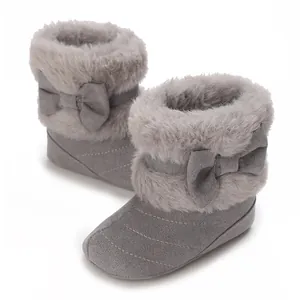 Detailed view of grey baby boots featuring soft faux fur trim and decorative bow accents.