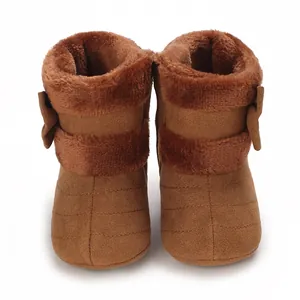 Front view of brown infant winter boots with plush fur lining and side bow detail