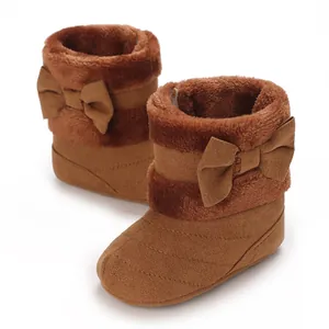 Detailed view of warm brown baby boots featuring plush lining and a charming side bow