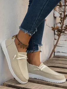 Women's beige canvas loafers with white sole and elastic laces for casual autumn wear
