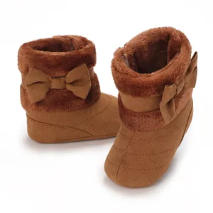 Cozy warm brown infant winter booties with soft fur trim and bow detail for baby girls.