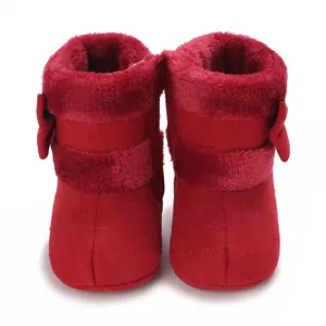 Front view of red infant soft-sole winter boots with plush lining and bow detail