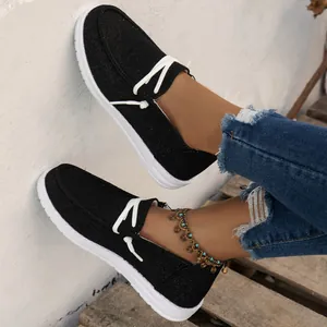 Lightweight black women's canvas loafers featuring white laces and comfortable white sole