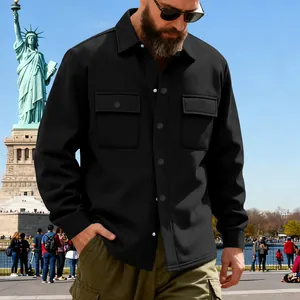 Detail shot of a black heavy-duty men's winter work jacket in a city park setting