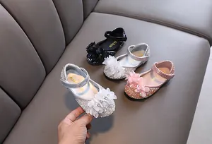 Detailed macro view of girls' sparkly rhinestone princess shoes in black, silver, and pink