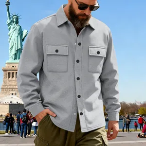 Male model wearing a grey heavy-duty work jacket against a city park background