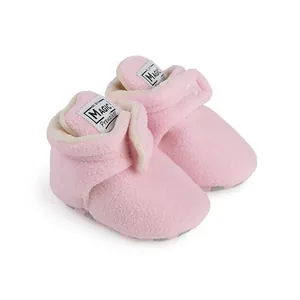 Detailed macro view of soft pink fleece baby winter prewalker shoes with magic tape