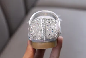 Close-up of sparkling silver rhinestone embellishments on girl's princess dance shoe