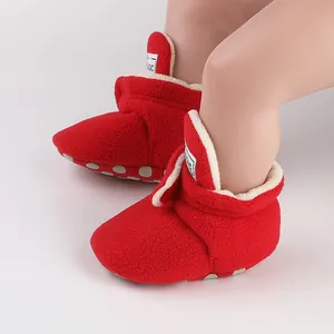 Detailed view of red winter fleece baby booties with warm white lining for infants