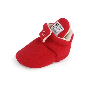 Detailed view of a soft red plush winter baby prewalker shoe with MAGIC brand label