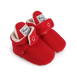 Close-up detail of cozy red fleece-lined baby pre-walker winter boots with warm lining.