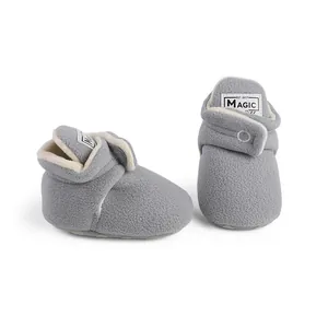 Detail of soft grey fleece winter baby booties with warm lining for infants