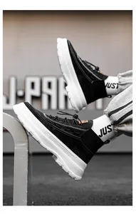 Detail of black high-top platform boots with suede texture and thick white sole